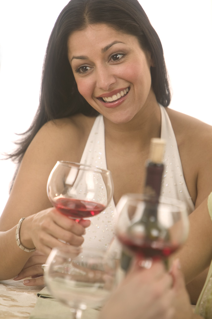 Woman Enjoying Glass of Wine with Friends January 30, 2004